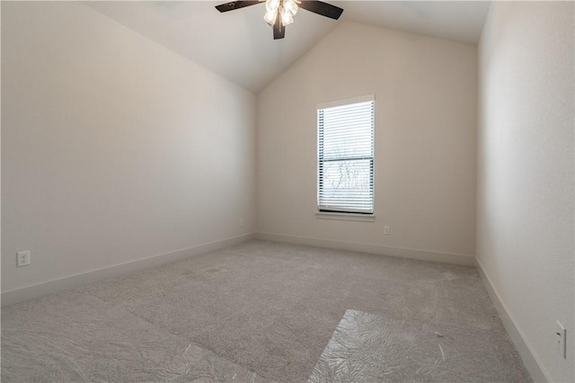 carpeted empty room with ceiling fan and lofted ceiling