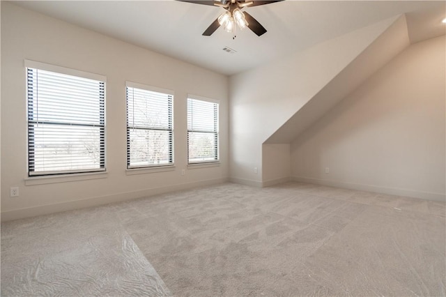 bonus room featuring light carpet and ceiling fan