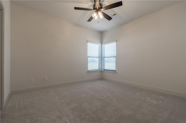 carpeted spare room featuring ceiling fan