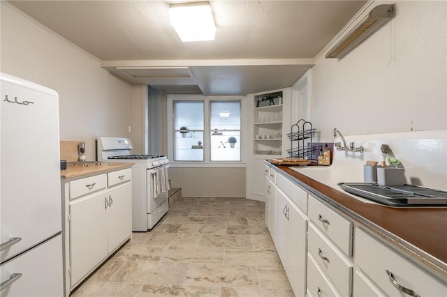 kitchen with white cabinetry and white appliances