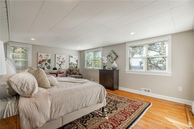 bedroom featuring hardwood / wood-style flooring and multiple windows