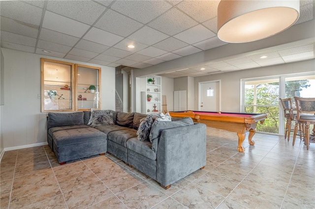 living room with a drop ceiling and pool table