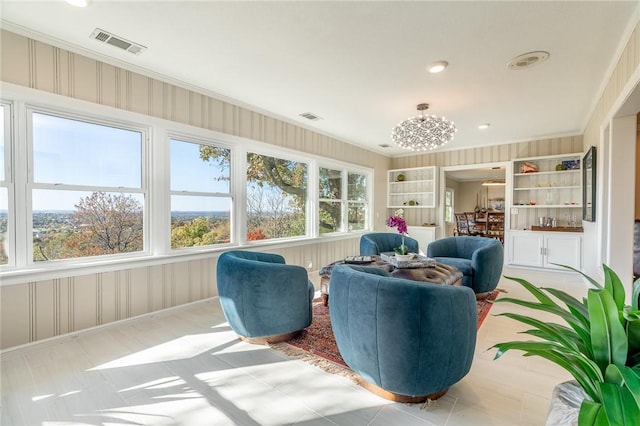 sunroom / solarium featuring a notable chandelier