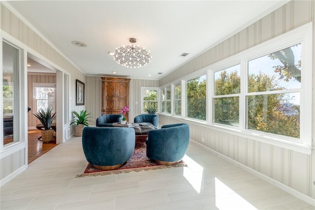 sunroom featuring plenty of natural light and a chandelier