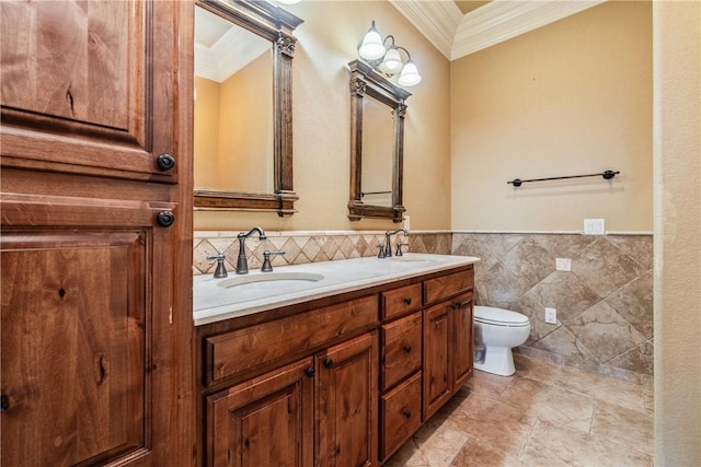 bathroom featuring vanity, toilet, tile walls, and ornamental molding