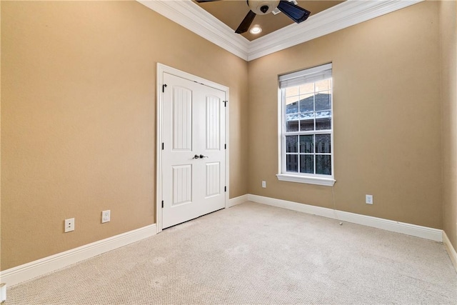 unfurnished bedroom with carpet flooring, ceiling fan, and ornamental molding