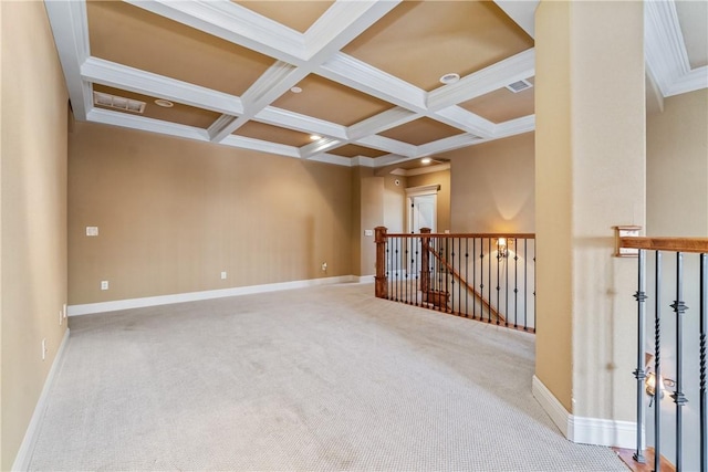 empty room featuring carpet, beamed ceiling, coffered ceiling, and ornamental molding