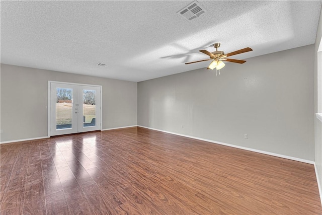 unfurnished room with ceiling fan, french doors, a textured ceiling, and hardwood / wood-style flooring