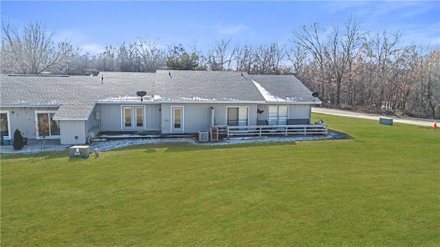 back of property featuring a lawn, central AC, and french doors