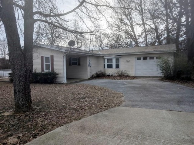 single story home with driveway and an attached garage