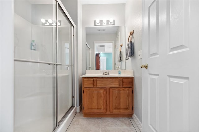 bathroom featuring tile patterned floors, vanity, and an enclosed shower