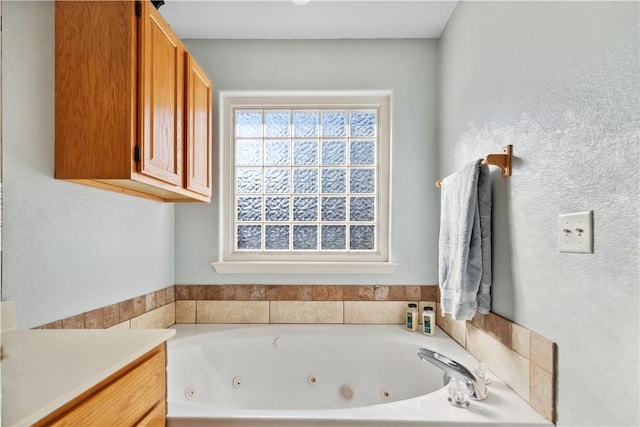 bathroom with a bathing tub and vanity