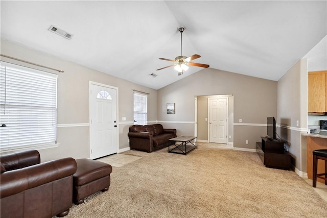 living room with ceiling fan, light carpet, and vaulted ceiling