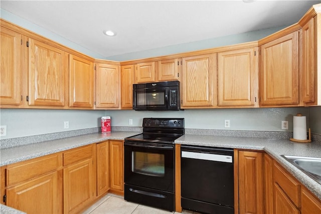 kitchen featuring light tile patterned flooring, sink, and black appliances