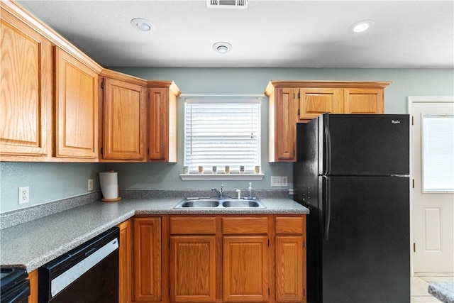 kitchen with light tile patterned floors, sink, a healthy amount of sunlight, and black appliances