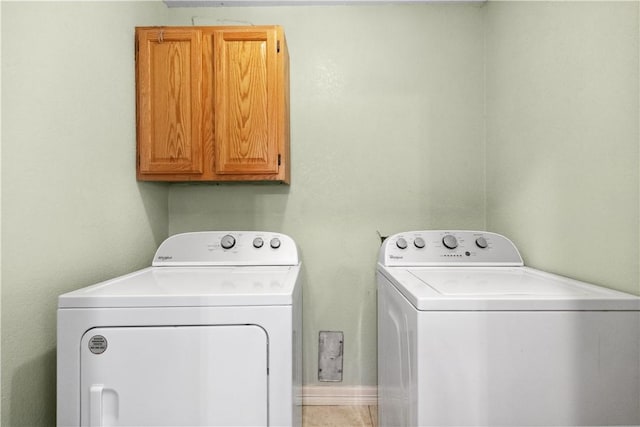 laundry area featuring cabinets and washing machine and clothes dryer