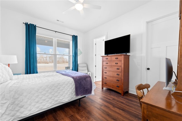 bedroom featuring visible vents, baseboards, a ceiling fan, and dark wood-style flooring