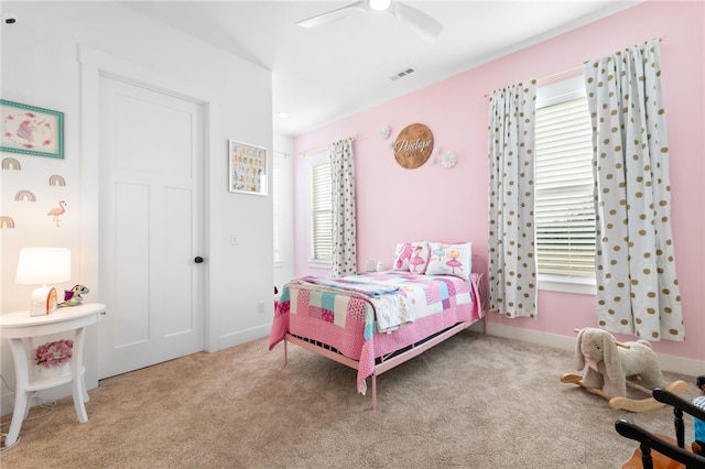 carpeted bedroom featuring visible vents, baseboards, and ceiling fan