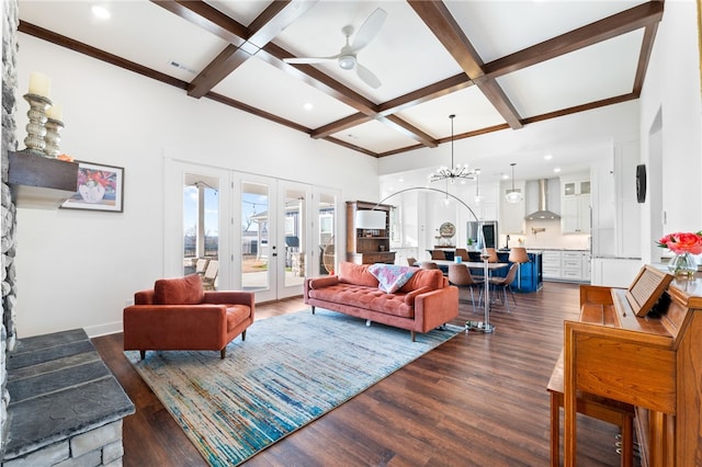 living room with beam ceiling, ceiling fan with notable chandelier, coffered ceiling, dark wood-style floors, and french doors