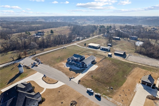 birds eye view of property with a rural view