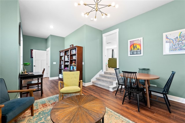 interior space featuring a chandelier, baseboards, wood finished floors, and stairs