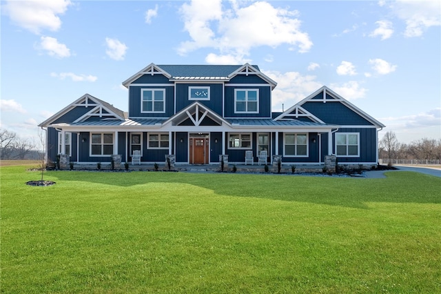 craftsman inspired home with a front lawn, a standing seam roof, a porch, board and batten siding, and metal roof