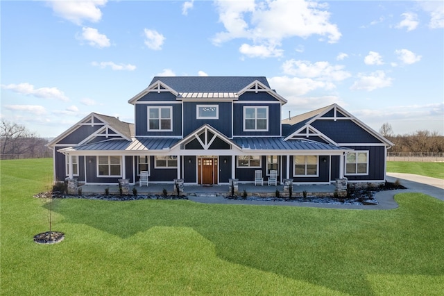 view of front of house with covered porch, board and batten siding, and a standing seam roof