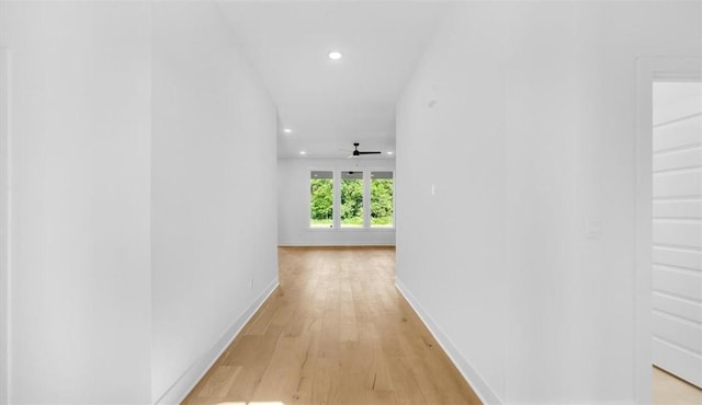 corridor with light hardwood / wood-style floors