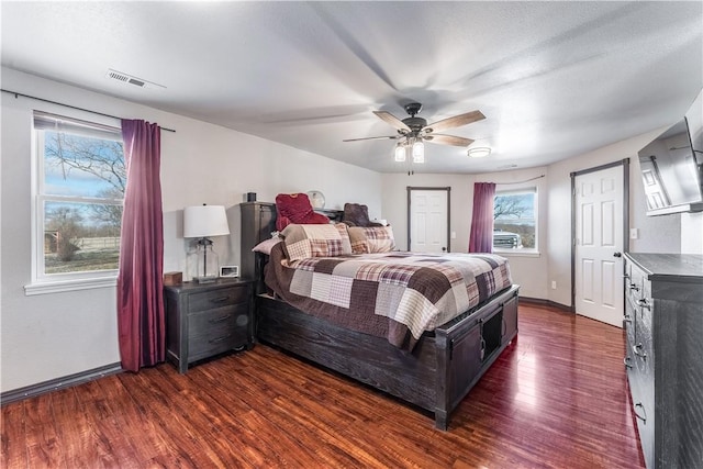 bedroom featuring ceiling fan and dark hardwood / wood-style floors