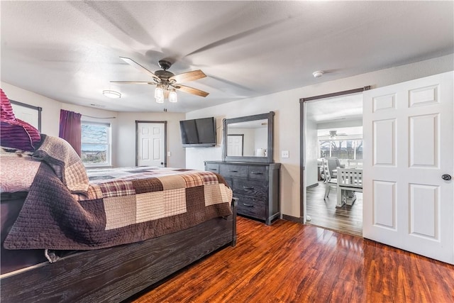 bedroom with dark wood-type flooring and ceiling fan