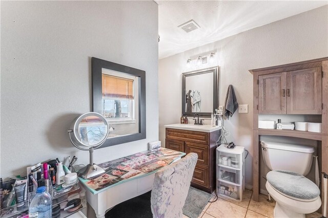 bathroom with tile patterned floors, vanity, and toilet