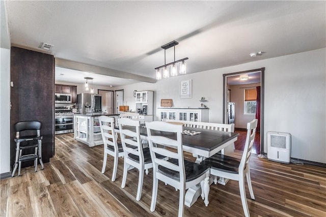 dining area with dark hardwood / wood-style flooring