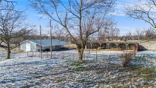 snowy yard featuring an outbuilding