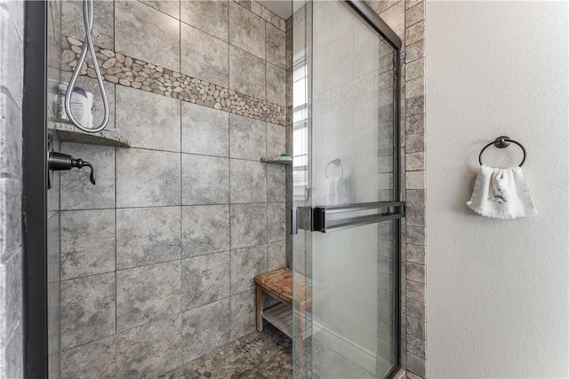 bathroom with a shower stall