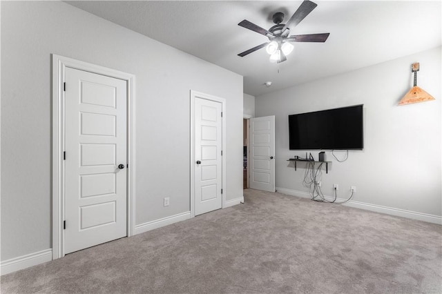 unfurnished bedroom featuring carpet flooring, ceiling fan, and baseboards