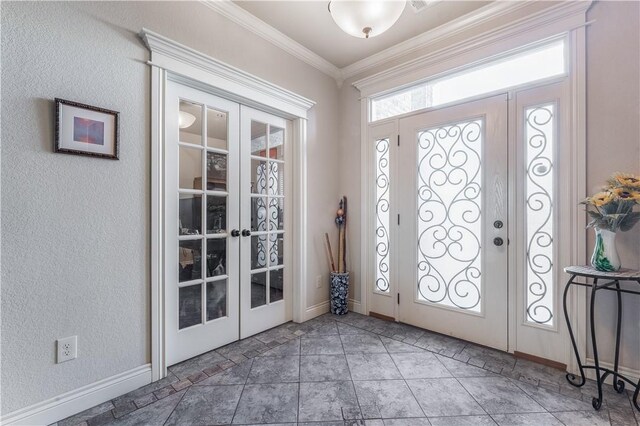 entryway with crown molding and french doors