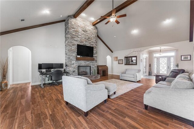 living room featuring ceiling fan, a fireplace, high vaulted ceiling, and beamed ceiling