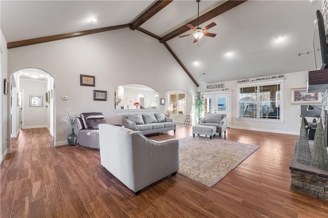 living room with visible vents, arched walkways, dark wood finished floors, high vaulted ceiling, and beam ceiling