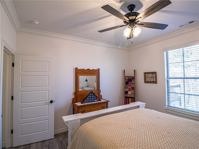 bedroom featuring ceiling fan, dark hardwood / wood-style flooring, and ornamental molding