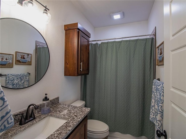 bathroom featuring curtained shower, vanity, and toilet