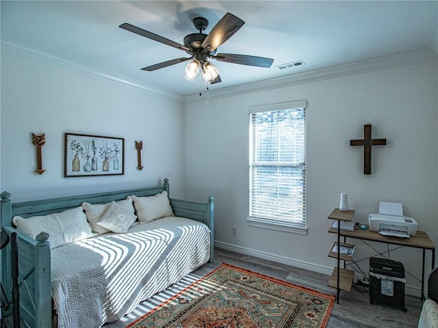 bedroom featuring ceiling fan, hardwood / wood-style flooring, and ornamental molding