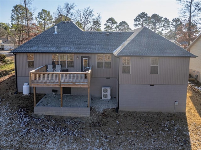 rear view of property with ac unit and a deck