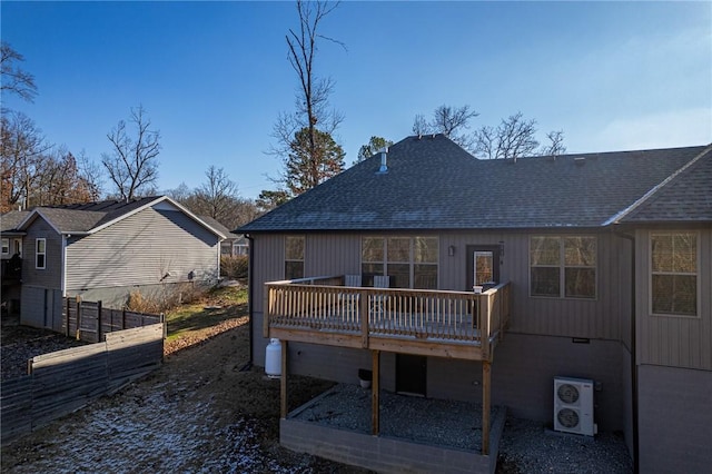 rear view of house with ac unit and a deck