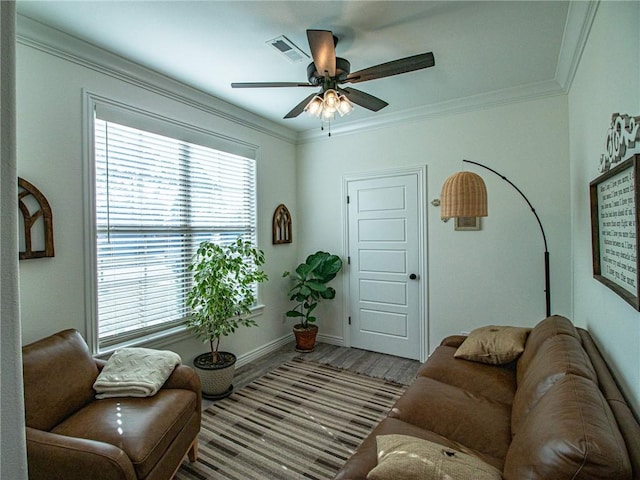 living room with light hardwood / wood-style flooring, ceiling fan, and crown molding