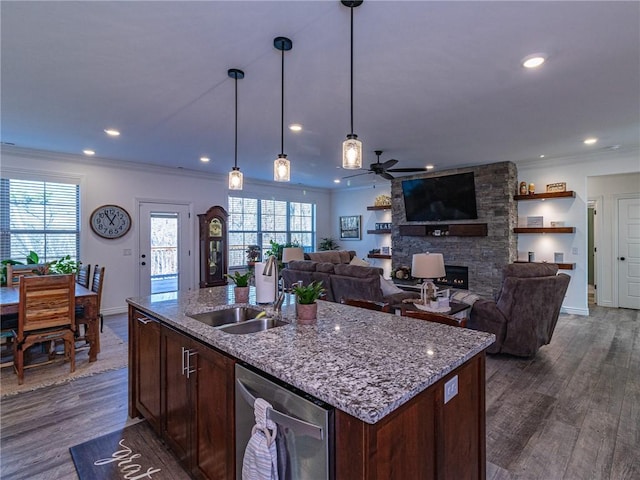 kitchen with dark hardwood / wood-style floors, a kitchen island with sink, ceiling fan, and sink