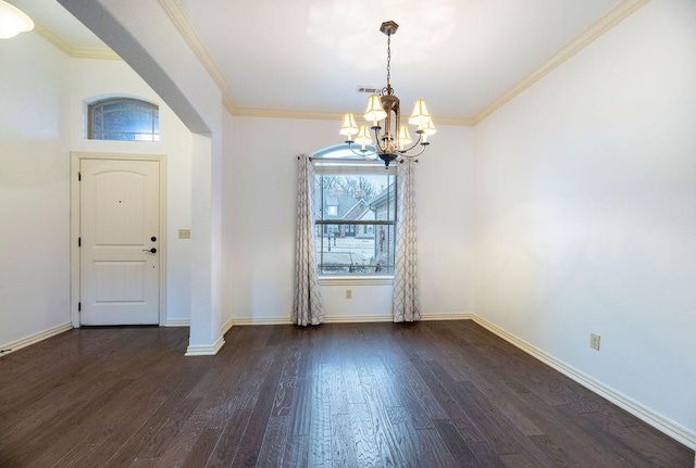 foyer entrance with a notable chandelier, dark hardwood / wood-style floors, and ornamental molding