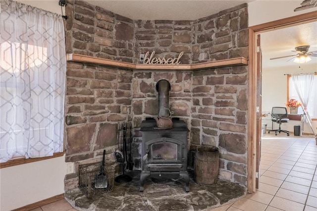 room details with a wood stove and ceiling fan