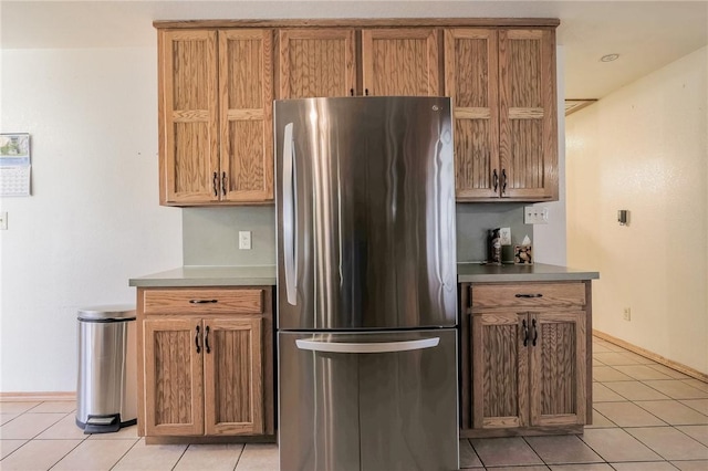 kitchen with stainless steel fridge and light tile patterned flooring