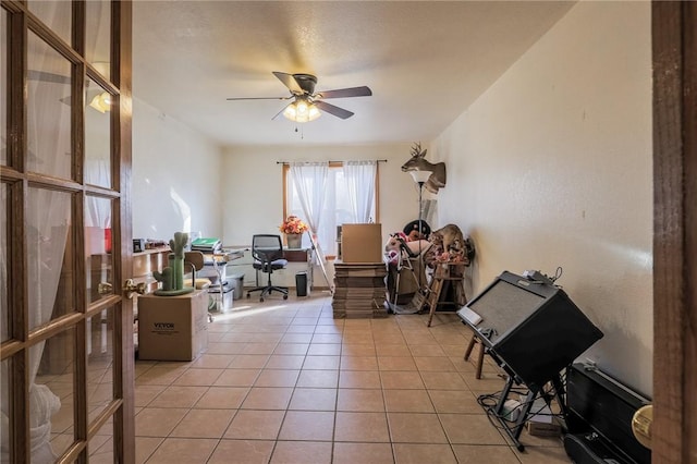 misc room featuring ceiling fan, light tile patterned flooring, and a textured ceiling