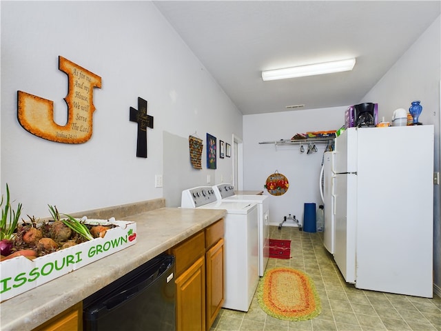 clothes washing area featuring light tile patterned floors, visible vents, laundry area, and washing machine and clothes dryer